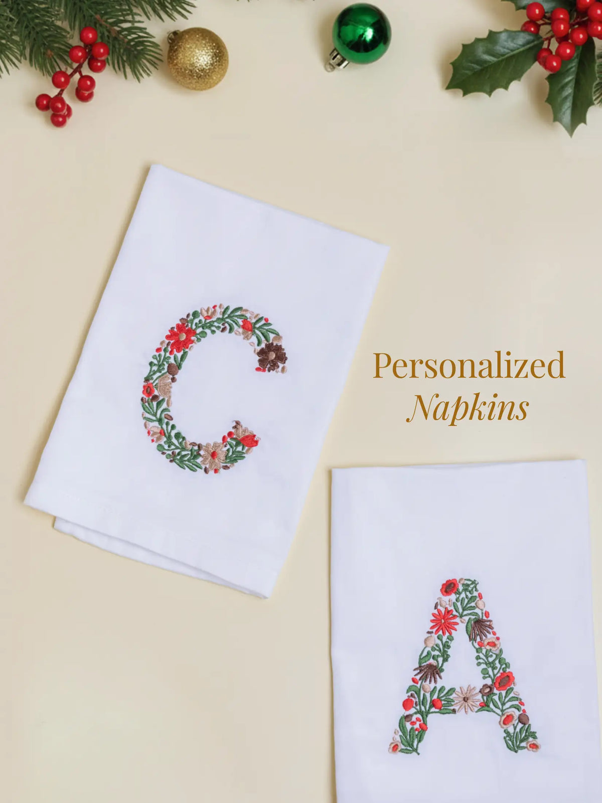 White personalized napkins embroidered with floral letters C and A, with the text Personalized Napkins