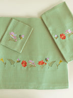 Olive green waffle bath, hand and face towels with bees and colourful garden flower embroidery