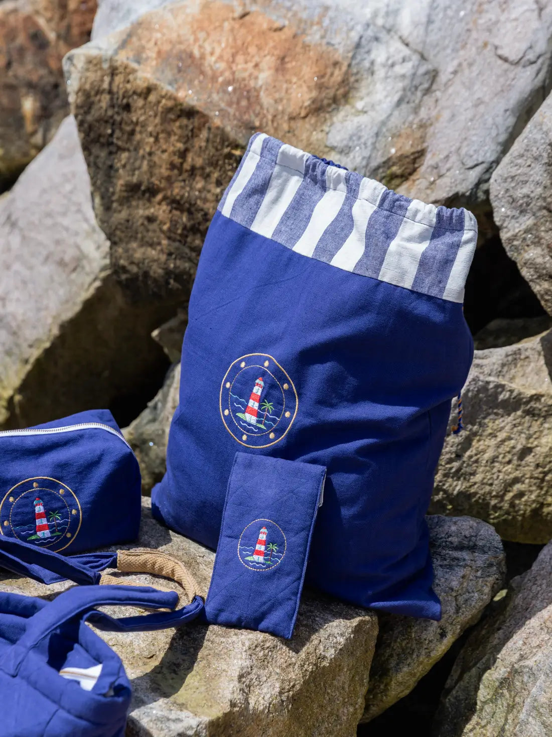 Navy blue lighthouse-embroidered laundry bag with matching toiletry bag, spectacle case and accessories