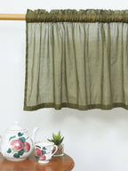 Olive green sheer cotton curtain with gathered rod pocket and darker border