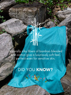 Teal tiger-embroidered towel with text stating that its bamboo and cotton blend has a soft feel suited to sensitive skin