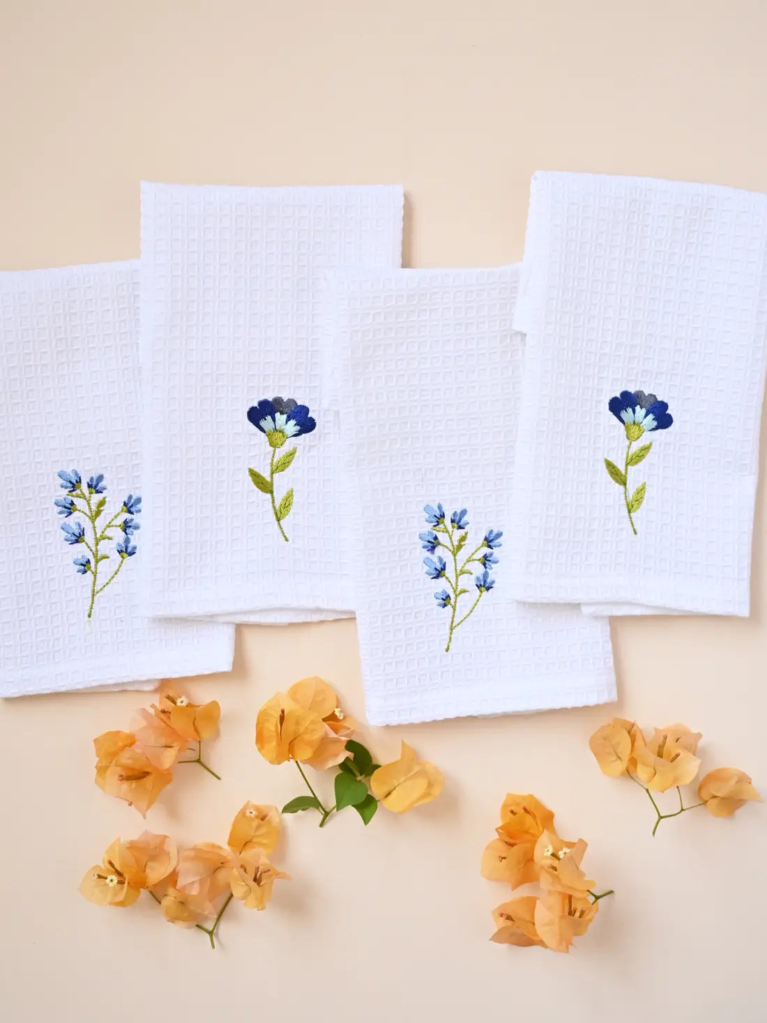White embroidered waffle face towel set of four with blue botanical motifs