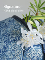 Close-up of blue geometric block-print fabric with the text Signature Hand block print